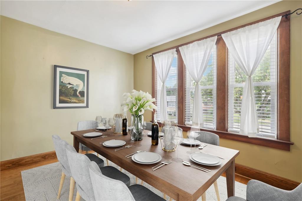 313 Pine Street Zelienople, PA 16063 - Photo 6 of 42 a view of a dining room with furniture large windows and wooden floor