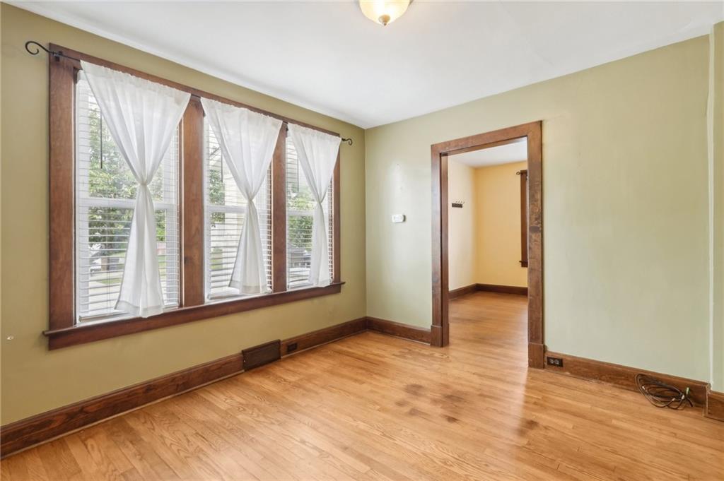 313 Pine Street Zelienople, PA 16063 - Photo 8 of 42 a view of an empty room with wooden floor and a window