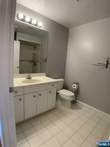 a bathroom with a sink mirror and toilet