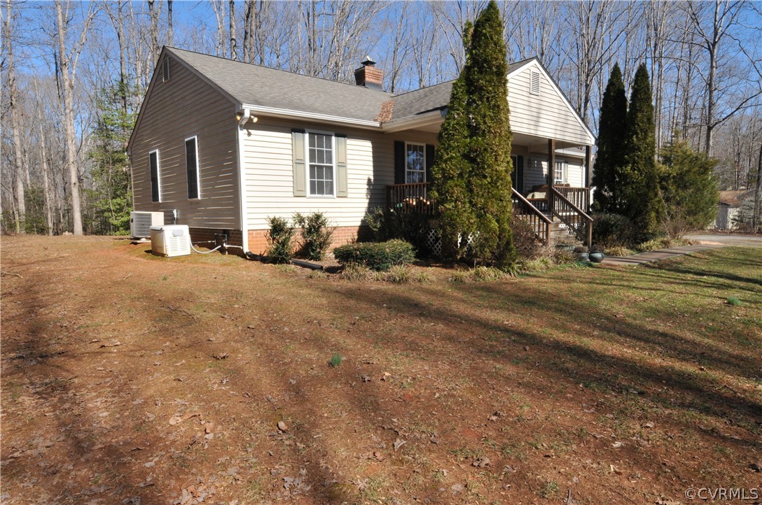 211 Rolling Path Road Louisa, VA 23093 - Photo 4 of 30 a front view of house with yard outdoor seating and barbeque oven