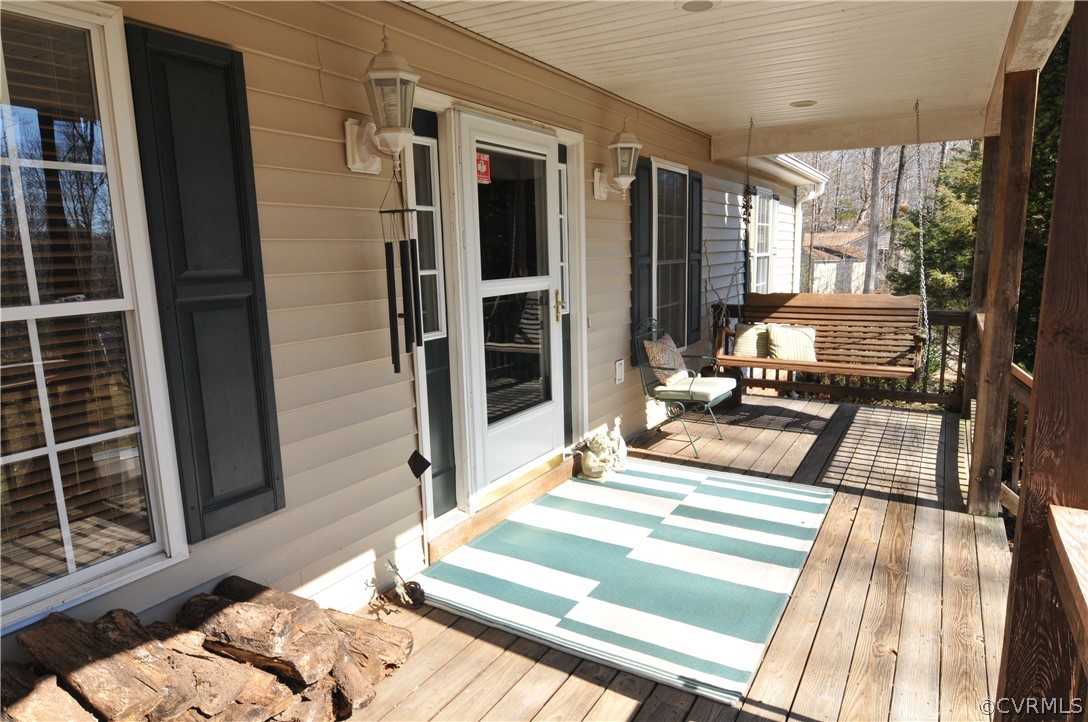 211 Rolling Path Road Louisa, VA 23093 - Photo 5 of 30 a view of a balcony with floor to ceiling windows and wooden floor