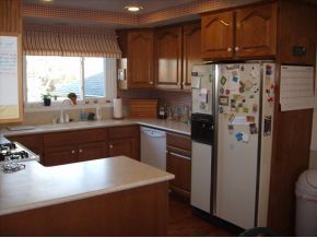 1806 Pony Soldier Road Prescott, AZ 86303 - Photo 7 of 9 a kitchen with stainless steel appliances granite countertop a refrigerator a sink dishwasher a stove and white countertops with wooden floor
