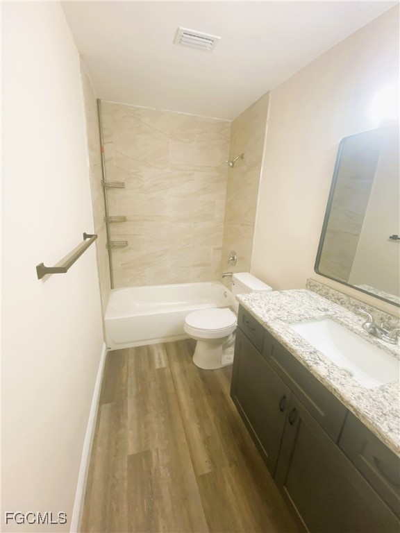 2247-2249 Violet Drive, Unit 2247 Fort Myers, FL 33905 - Photo 4 of 9 a bathroom with a granite countertop sink a toilet and shower