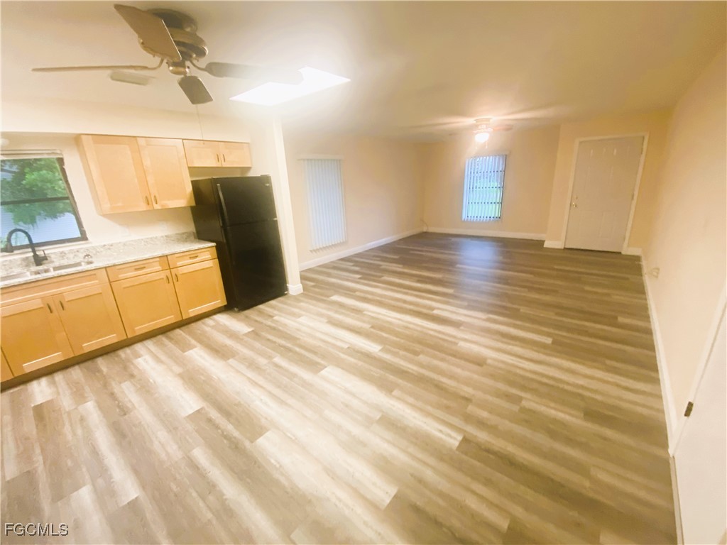 2247-2249 Violet Drive, Unit 2247 Fort Myers, FL 33905 - Photo 5 of 9 a view of a room with wooden floor and white walls