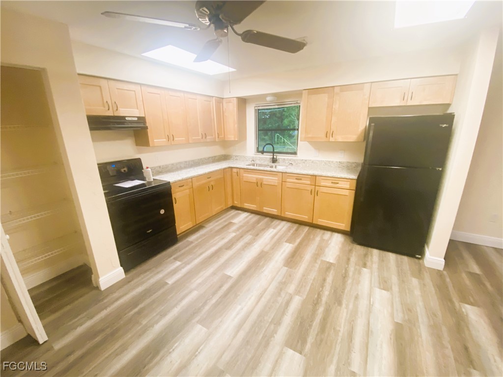 2247-2249 Violet Drive, Unit 2247 Fort Myers, FL 33905 - Photo 6 of 9 a kitchen with a sink stove and refrigerator