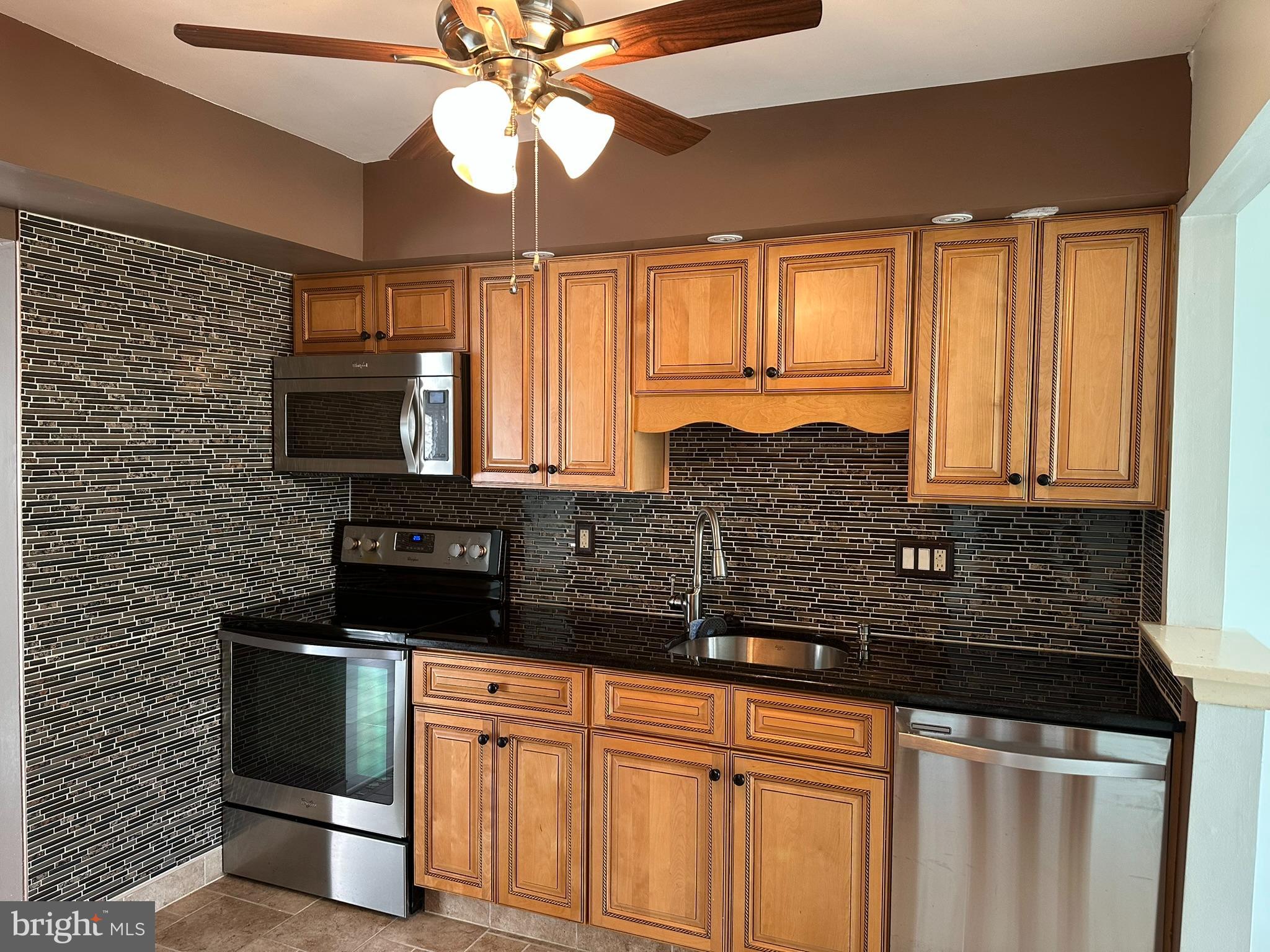 77 Kanabe Drive Westampton, NJ 08060 - Photo 10 of 30 a kitchen with stainless steel appliances granite countertop a sink a stove and cabinets