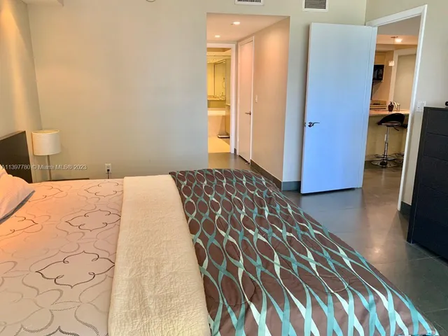 a living room with a flat screen tv and a window