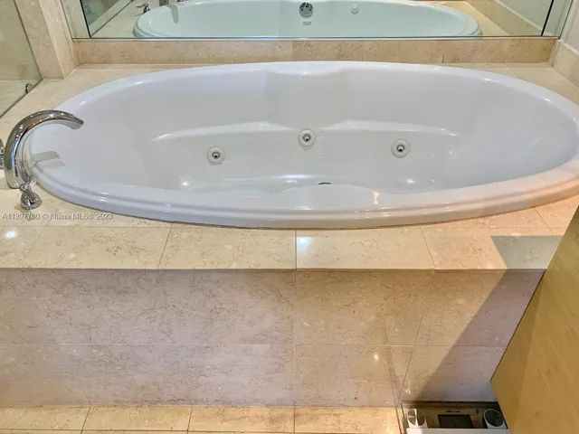 a bed sitting in a bedroom with dressers