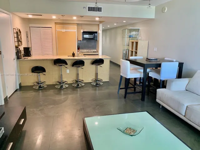 a kitchen with a sink and chairs
