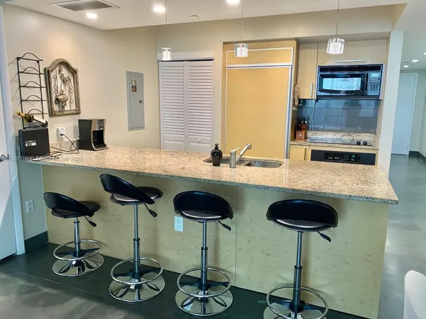 a kitchen with a stove microwave and refrigerator