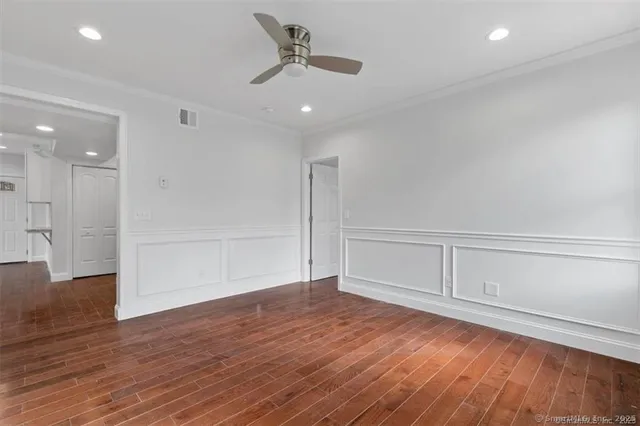 a view of an empty room with wooden floor