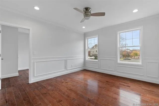 wooden floor in an empty room with a window