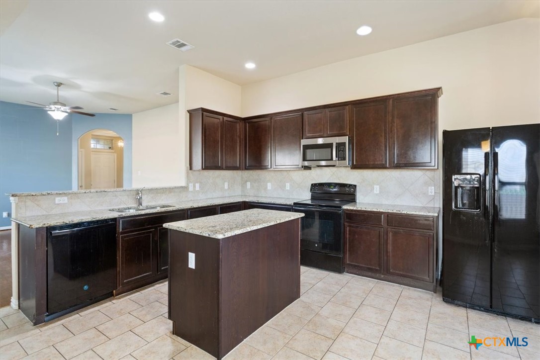 4019 Brookhaven Drive Temple, TX 76504 - Photo 12 of 25 a kitchen with stainless steel appliances granite countertop a stove a sink and a refrigerator