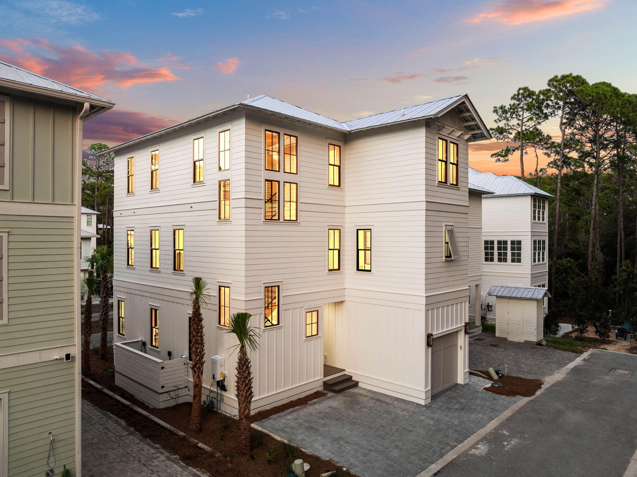 143 Redbud Ln Inlet Beach Inlet Beach, FL 32461 - Photo 5 of 62 a view of a white house with large windows and potted plants