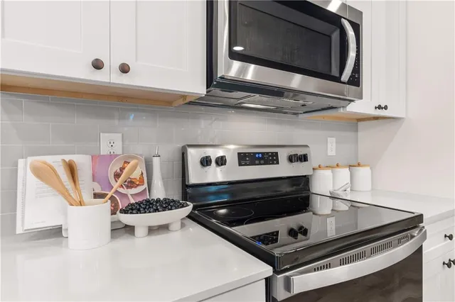 a stove top oven sitting inside of a kitchen
