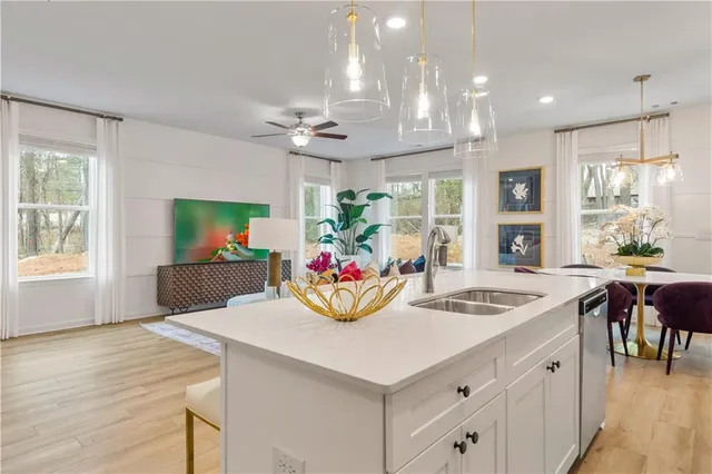 a view of a dining room with furniture a chandelier and wooden floor
