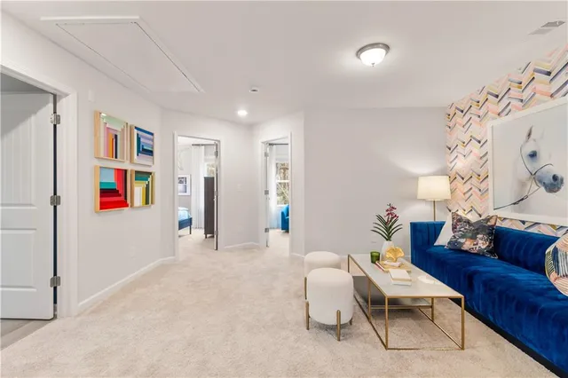 a living room with furniture and a book shelf