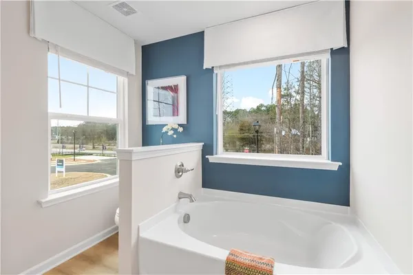a white bath tub sitting next to a window