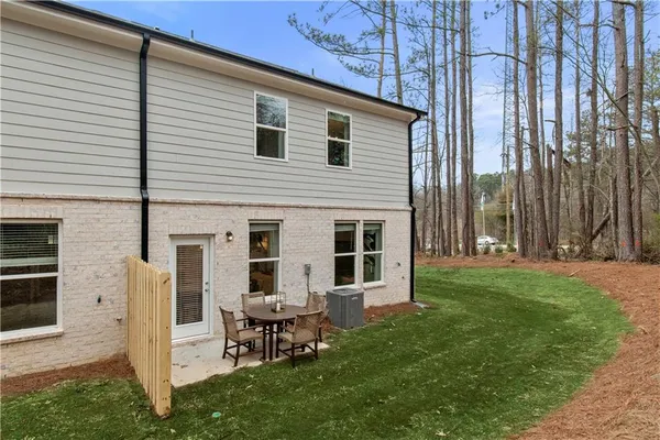 a backyard of a house with table and chairs