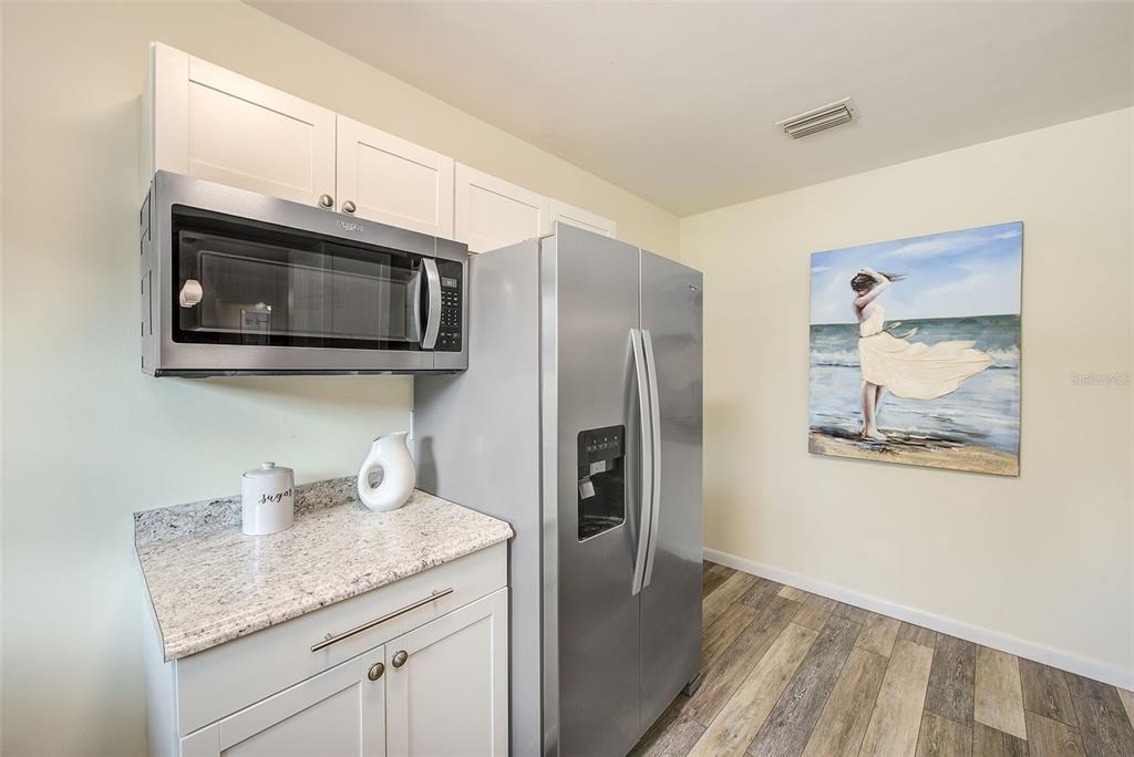 14079 Victoria Road Largo, FL 33774 - Photo 13 of 46 a kitchen with stainless steel appliances granite countertop a refrigerator microwave and sink