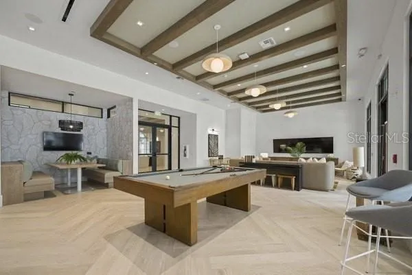 a large kitchen with kitchen island a stove a sink a dining table and chairs