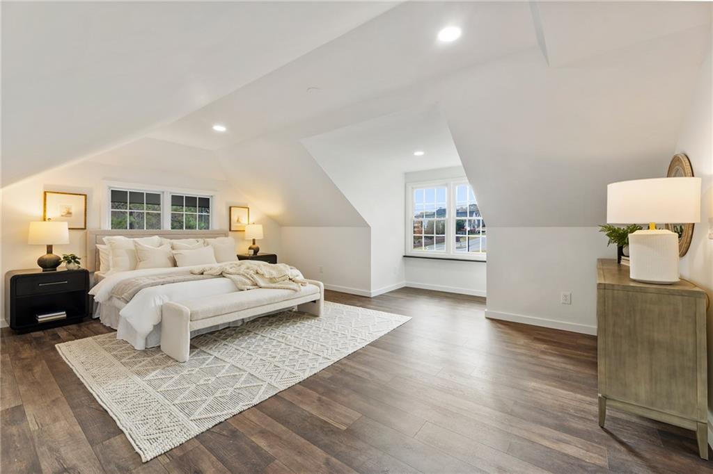 14440 Cogburn Road Alpharetta, GA 30004 - Photo 6 of 62 a spacious bedroom with a bed and wooden floor
