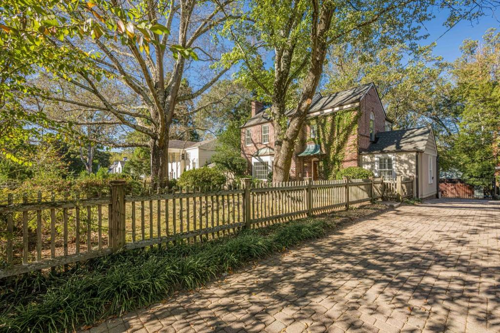 a view of a yard with wooden fence