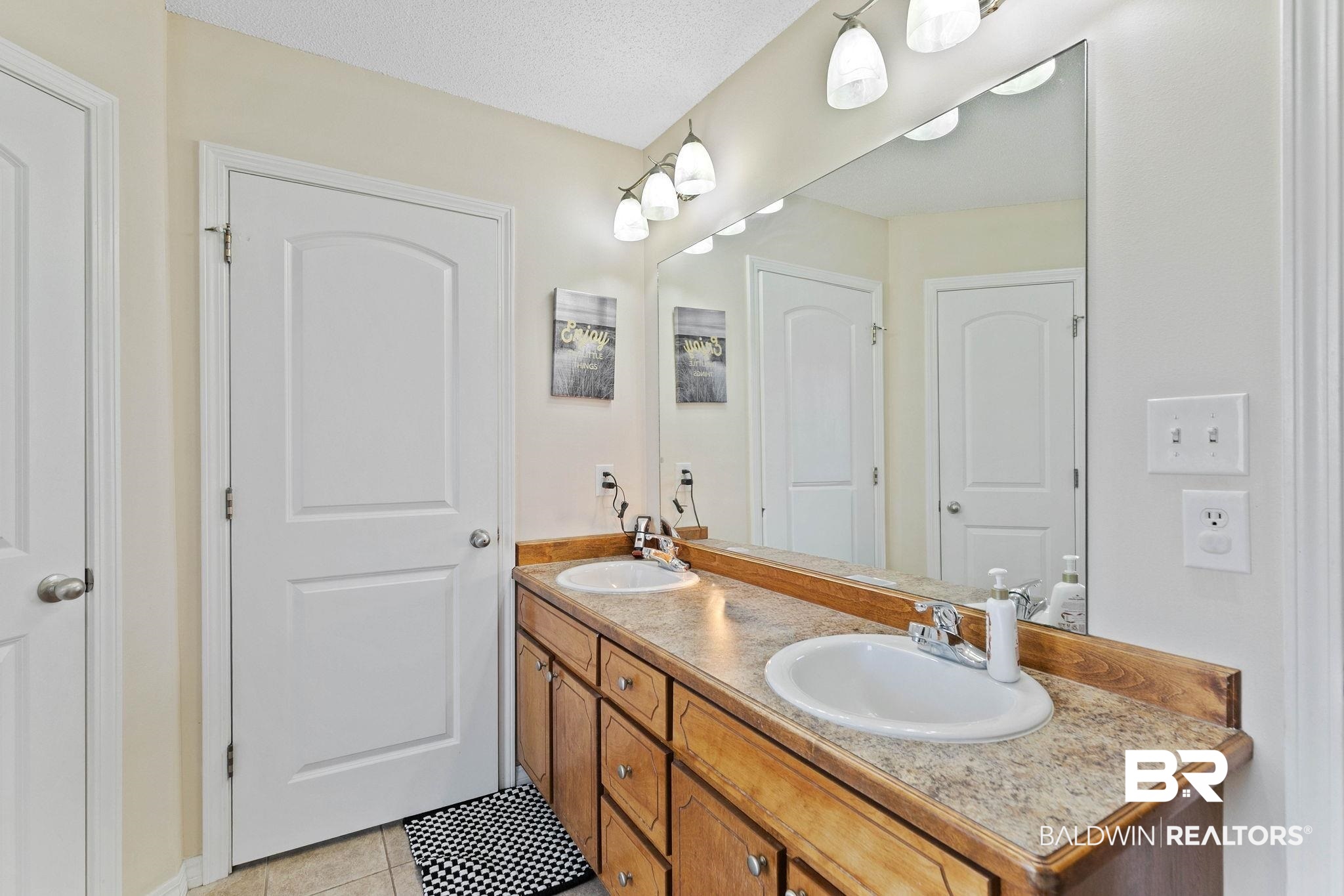 55750 Lottie Road Perdido, AL 36562 - Photo 53 of 84 Full bath with double vanity and light tile patterned flooring