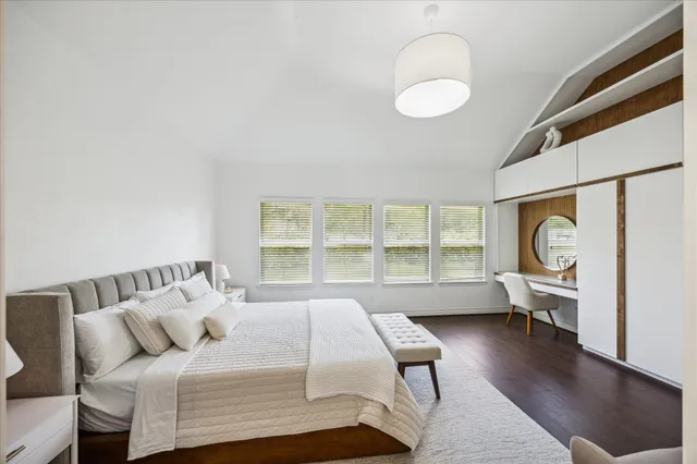 a bedroom with a bed and a large window