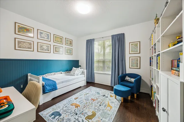 a bedroom with furniture and a potted plant