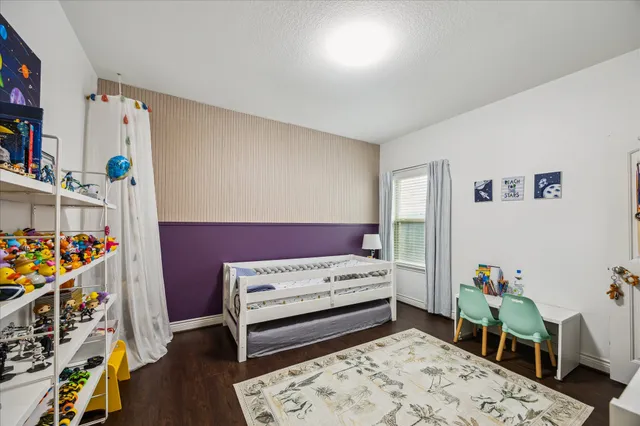 a bedroom with furniture and a wooden floor