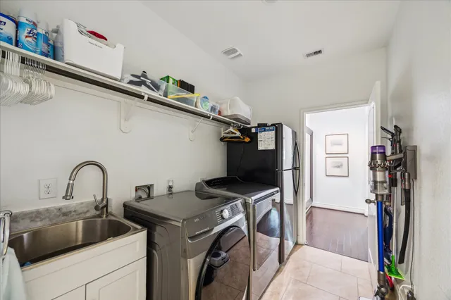 a view of a sink a washer and dryer