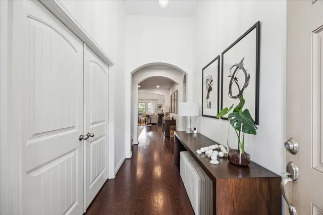 a view of a hallway view with wooden floor and furniture