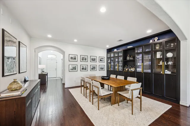 a dining room with furniture and wooden floor