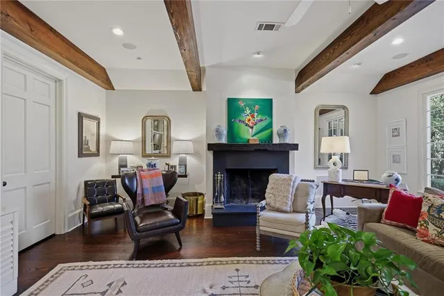 a living room with fireplace furniture and a wooden floor