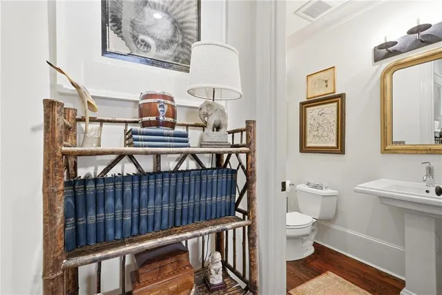 a bathroom with a toilet a sink and a window