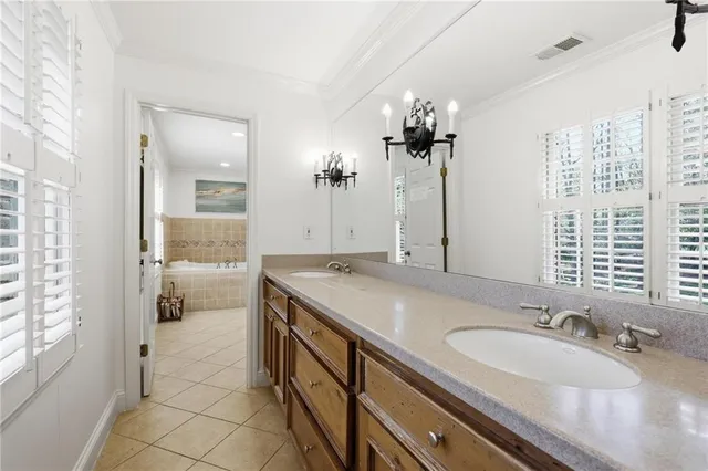 a bathroom with a granite countertop sink a mirror and a shower