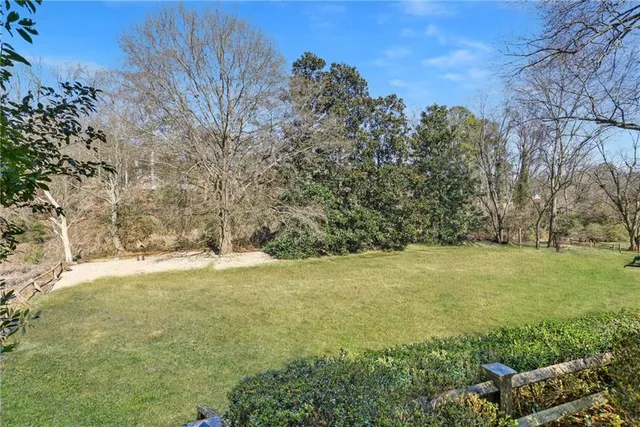 a view of empty field with trees