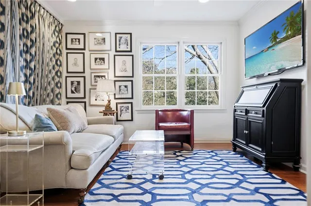 a living room with furniture a rug and a flat screen tv