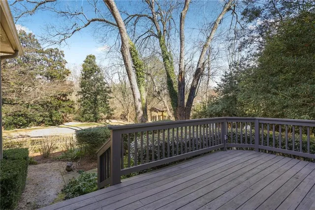 a balcony with wooden floor and fence