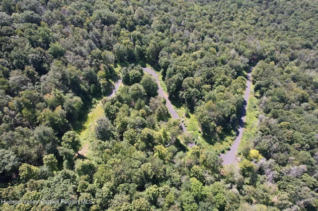 an aerial view of a houses with a yard