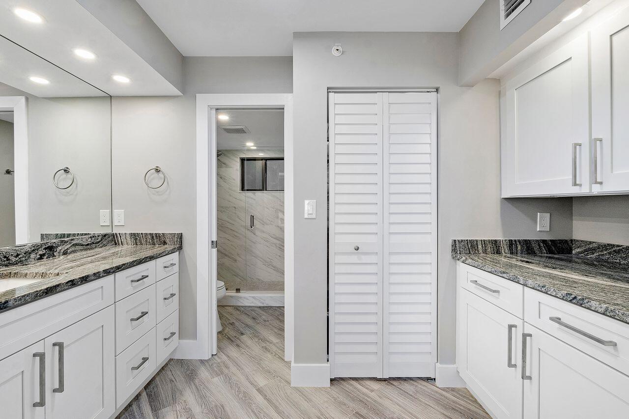 200 Ocean Trail Way, Unit 602 Jupiter, FL 33477 - Photo 20 of 50 a spacious bathroom with a granite countertop sink a mirror and a shower