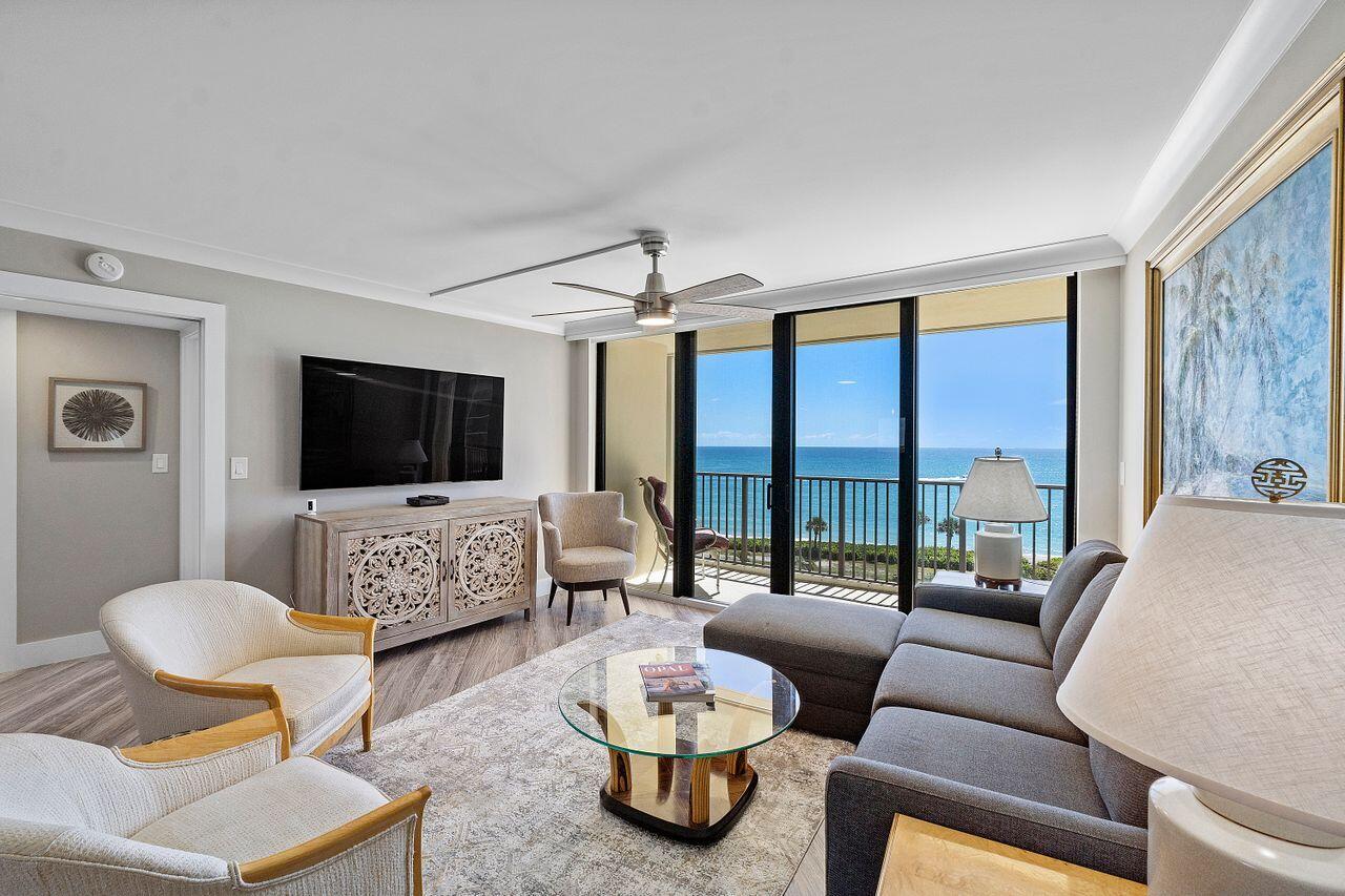 200 Ocean Trail Way, Unit 602 Jupiter, FL 33477 - Photo 2 of 50 a living room with furniture and a flat screen tv
