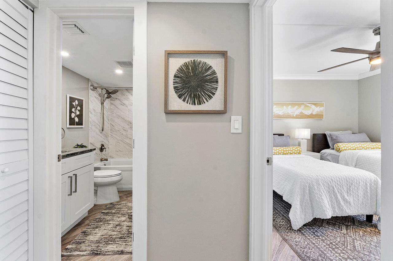 200 Ocean Trail Way, Unit 602 Jupiter, FL 33477 - Photo 26 of 50 a en suite bathroom with a granite countertop sink and a mirror