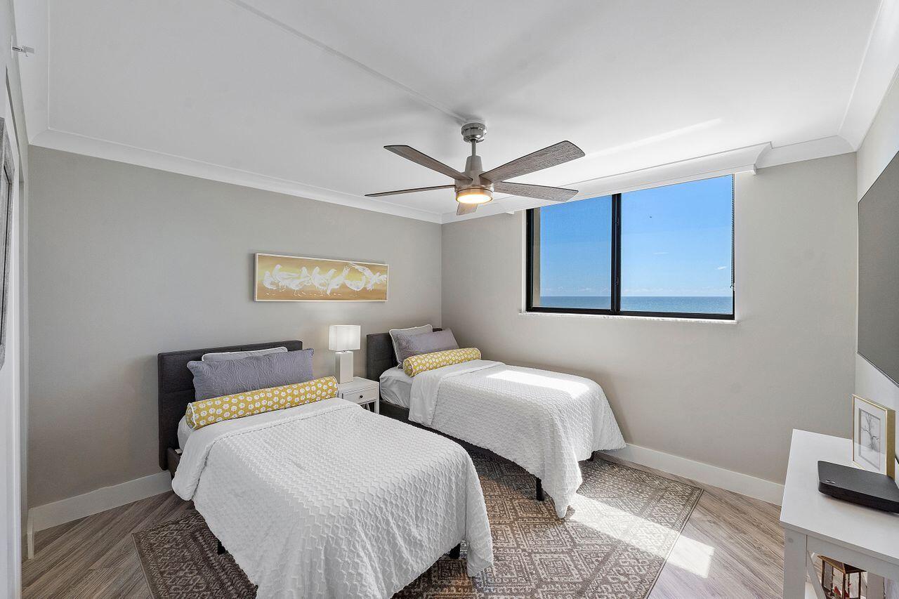 200 Ocean Trail Way, Unit 602 Jupiter, FL 33477 - Photo 27 of 50 a bedroom with two beds and a ceiling fan