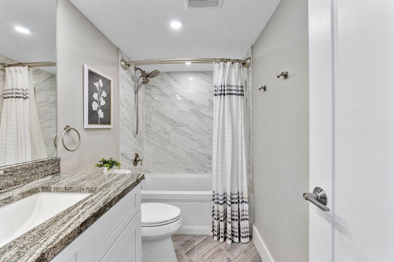 200 Ocean Trail Way, Unit 602 Jupiter, FL 33477 - Photo 31 of 50 a bathroom with a granite countertop sink toilet and shower