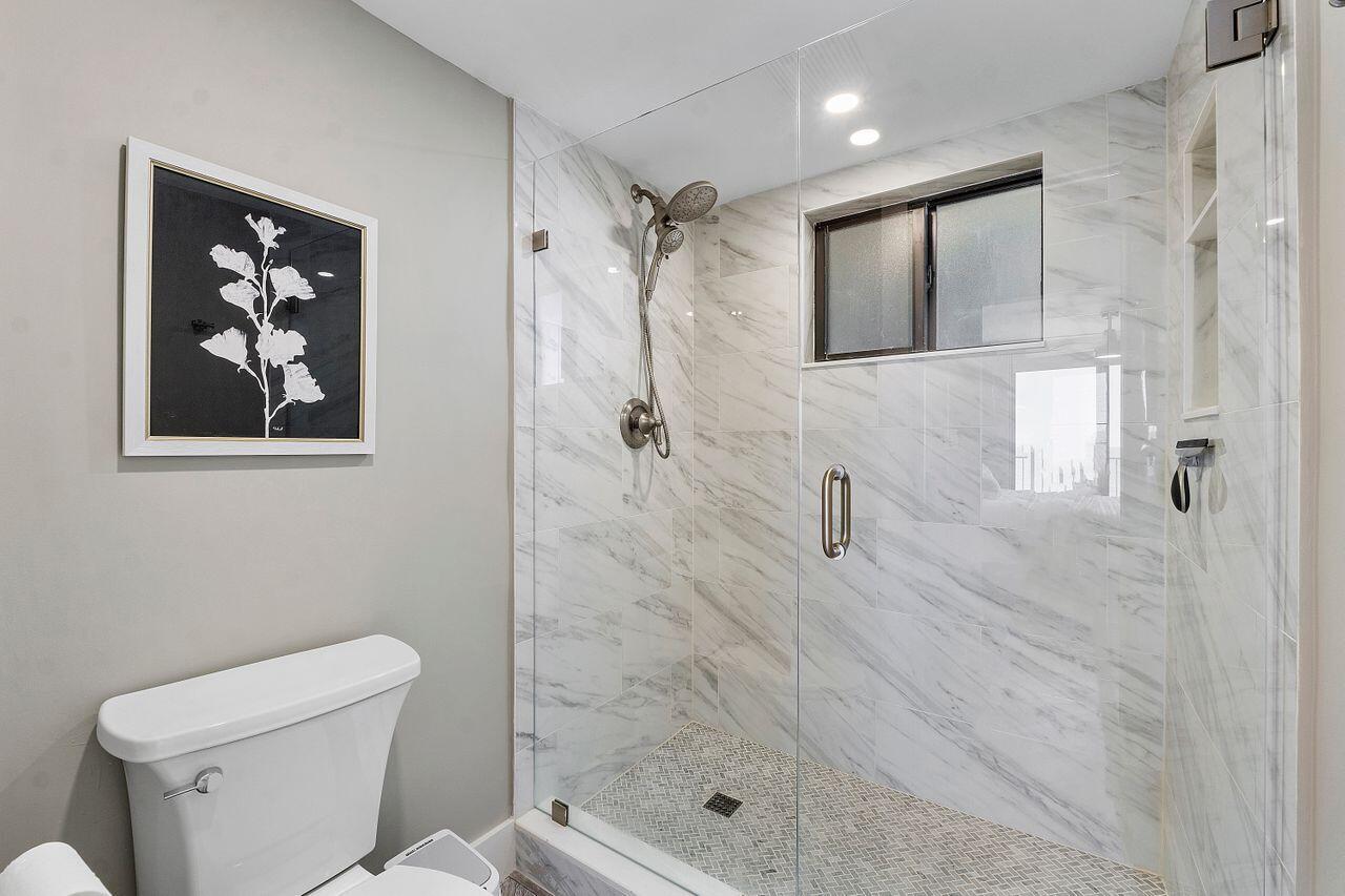 200 Ocean Trail Way, Unit 602 Jupiter, FL 33477 - Photo 32 of 50 a bathroom with a shower a toilet and sink