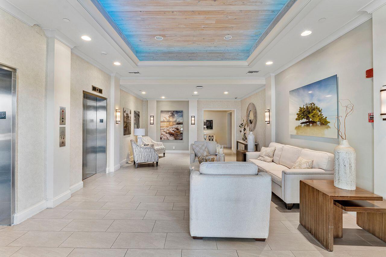 200 Ocean Trail Way, Unit 602 Jupiter, FL 33477 - Photo 46 of 50 a living room with furniture and a kitchen view