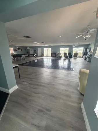 a living room with furniture and kitchen view