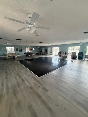 a dining room with furniture a window and wooden floor